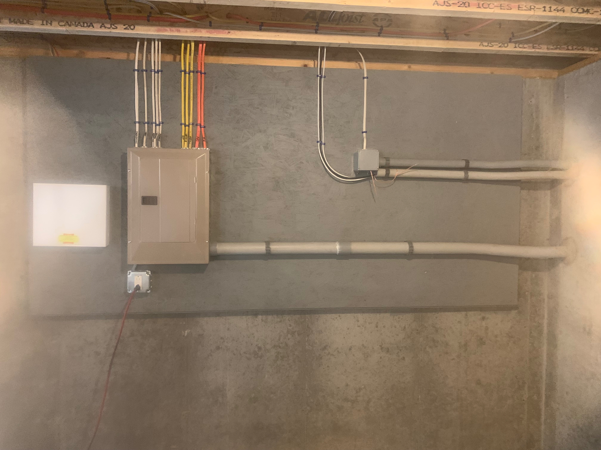 Clean conduit run and subpanel install in a finished basement by Andrew