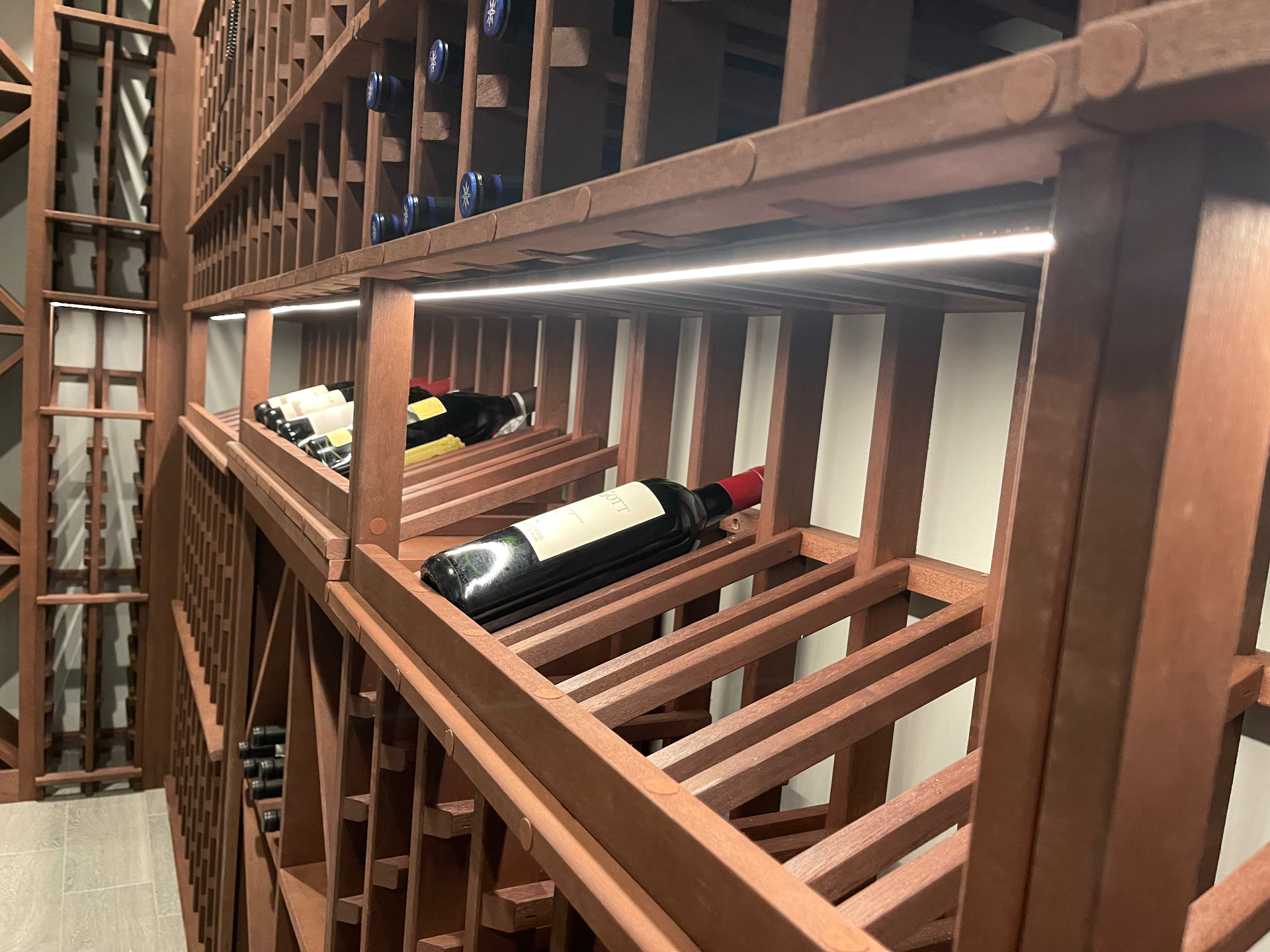 Custom LED lighting in a residential wine cellar by Andrew