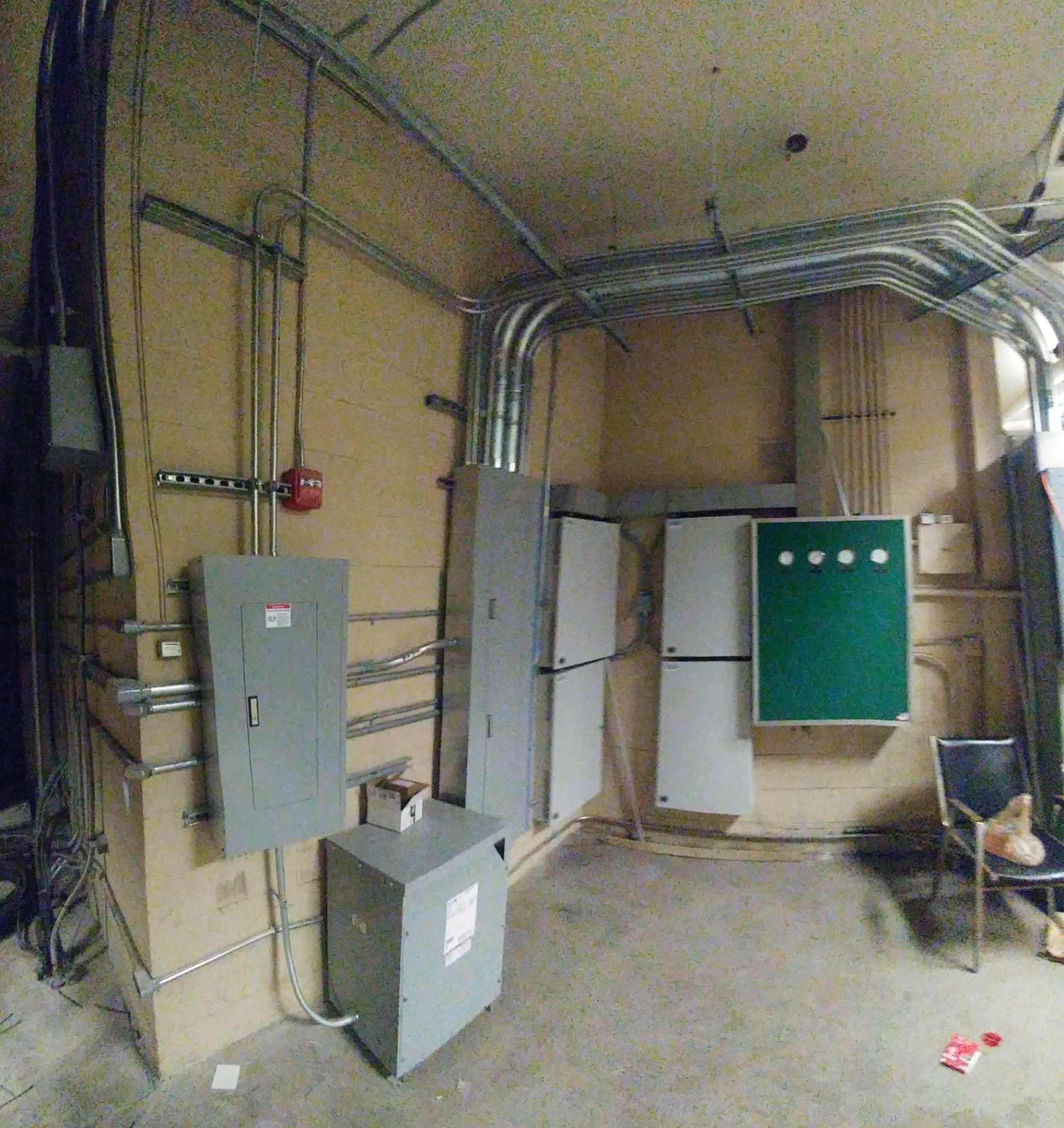 Industrial mechanical room with sub-panels, transformer, and organized branch circuit conduit